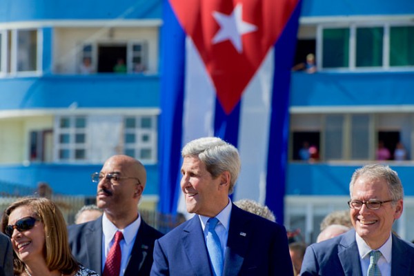 John Kerry Laughs as the Crowd Across the Street Yells "Viva Cuba" at End of Playing of Cuban National Anthem. 